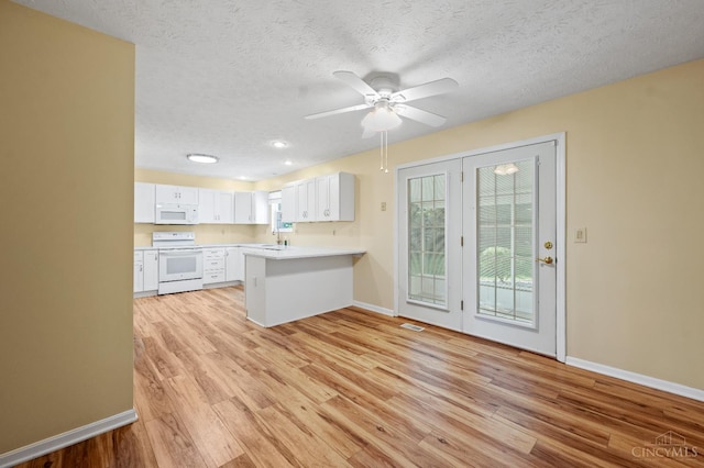 125 Sackett Dr, Monroe, OH 45050 - kitchen with white appliances, a peninsula, light wood-style floors, a ceiling fan, and a textured ceiling