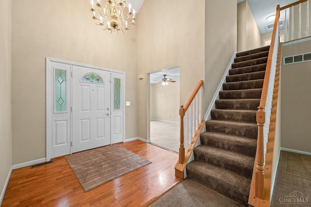 125 Sackett Dr, Monroe, OH 45050 - entryway with stairs, wood finished floors, a chandelier, a high ceiling, and ceiling fan