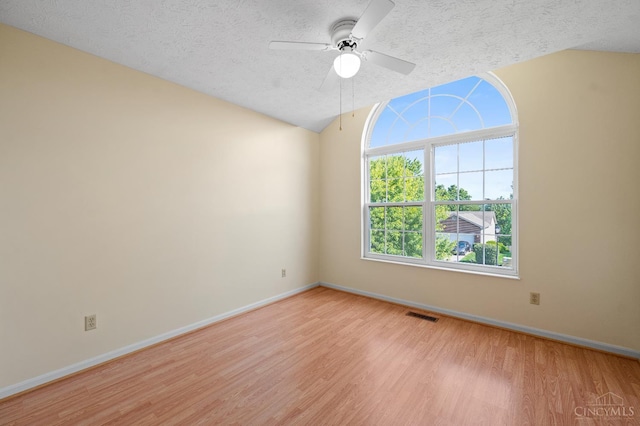 125 Sackett Dr, Monroe, OH 45050 - unfurnished room featuring light wood-style floors, ceiling fan, a textured ceiling, and lofted ceiling