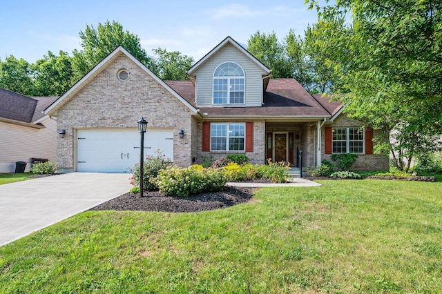 125 Sackett Dr, Monroe, OH 45050 - view of front of house featuring brick siding, an attached garage, concrete driveway, and a front yard
