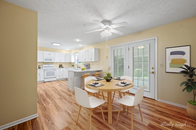 125 Sackett Dr, Monroe, OH 45050 - dining room featuring light wood-style flooring, a textured ceiling, and a ceiling fan