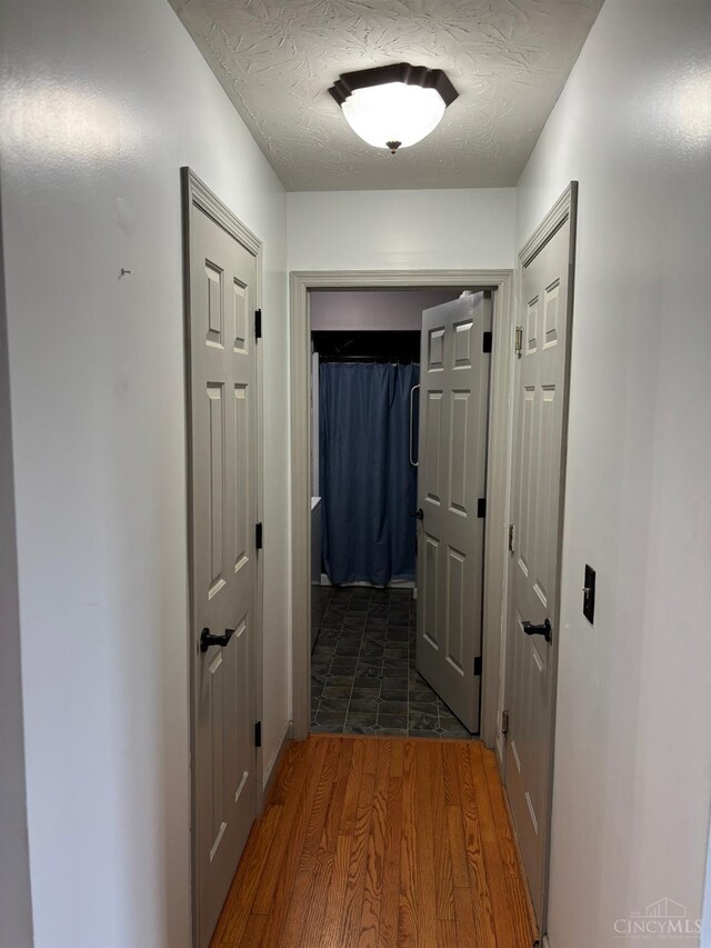 742 Miami Way Dr, Hamilton, OH 45013 - hall featuring wood finished floors and a textured ceiling