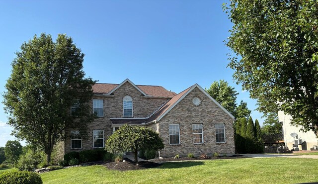 742 Miami Way Dr, Hamilton, OH 45013 - traditional home featuring a front lawn and brick siding