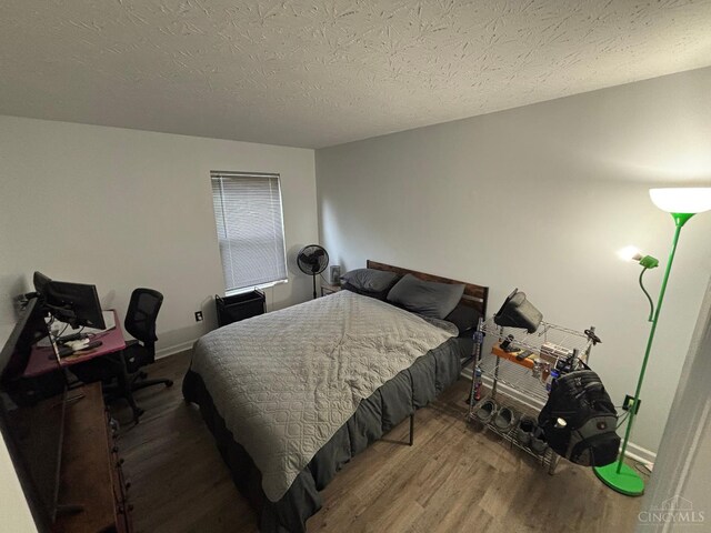 742 Miami Way Dr, Hamilton, OH 45013 - bedroom with wood finished floors, a textured ceiling, and an office area
