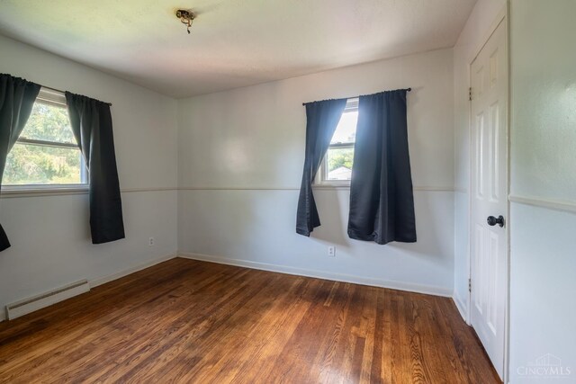 251 Westview Dr, Morrow, OH 45152 - spare room featuring baseboard heating, wood finished floors, and plenty of natural light