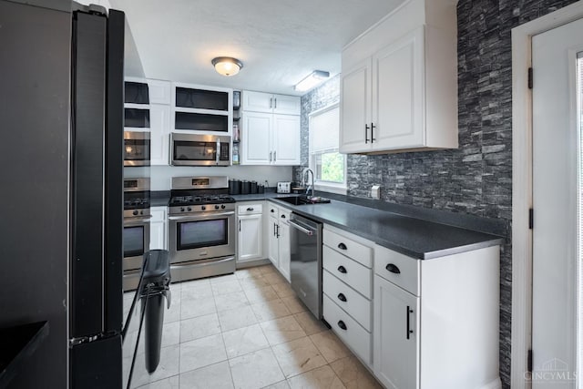 251 Westview Dr, Morrow, OH 45152 - kitchen featuring appliances with stainless steel finishes, dark countertops, white cabinets, and light tile patterned floors