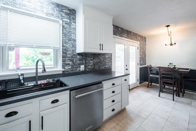 251 Westview Dr, Morrow, OH 45152 - kitchen featuring stainless steel dishwasher, dark countertops, healthy amount of natural light, and white cabinetry