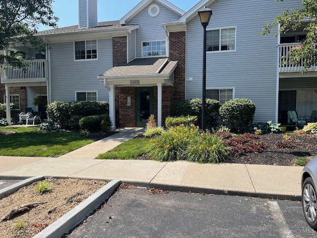 12061 Carrington Ln Unit 206, Symmes Twp, OH 45140 - view of front of property with brick siding and a chimney