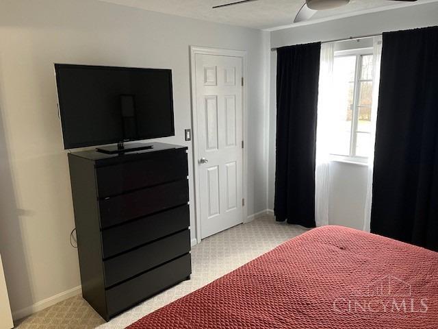 12061 Carrington Ln Unit 206, Symmes Twp, OH 45140 - bedroom with light colored carpet and a ceiling fan