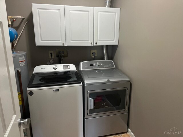 12061 Carrington Ln Unit 206, Symmes Twp, OH 45140 - laundry area featuring independent washer and dryer, cabinet space, and water heater