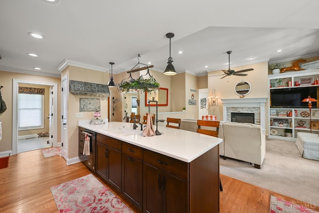 18092 Horizon Way, Lawrenceburg, IN 47025 - kitchen featuring ceiling fan, crown molding, a peninsula, light wood-style floors, and light countertops