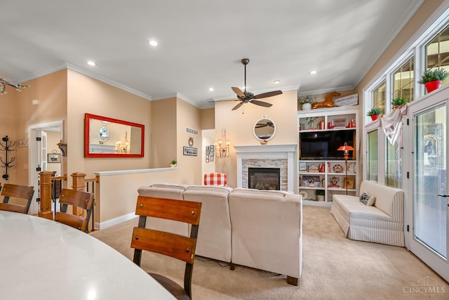 18092 Horizon Way, Lawrenceburg, IN 47025 - living room with light carpet, ornamental molding, ceiling fan, recessed lighting, and a stone fireplace