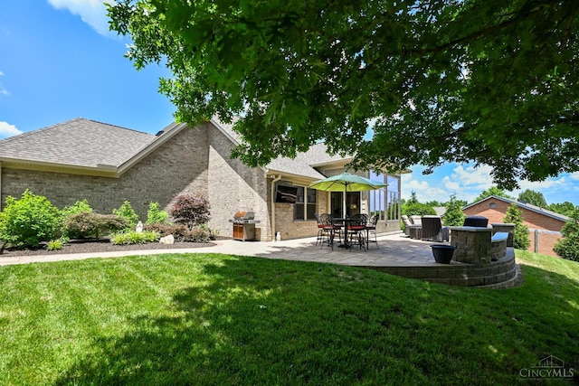 18092 Horizon Way, Lawrenceburg, IN 47025 - back of property featuring a patio, a yard, brick siding, and a shingled roof