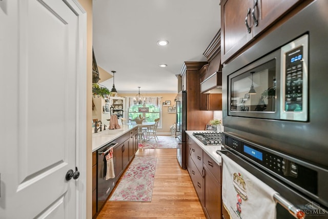 18092 Horizon Way, Lawrenceburg, IN 47025 - kitchen with stainless steel appliances, light wood-style floors, light countertops, a chandelier, and recessed lighting