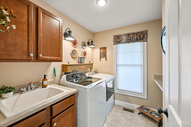 18092 Horizon Way, Lawrenceburg, IN 47025 - laundry room with cabinet space, washing machine and dryer, and light tile patterned floors