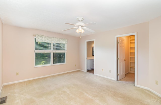 7693 Misty Springs Ct, Deerfield Twp, OH 45040 - unfurnished bedroom featuring carpet flooring, a walk in closet, connected bathroom, and a ceiling fan