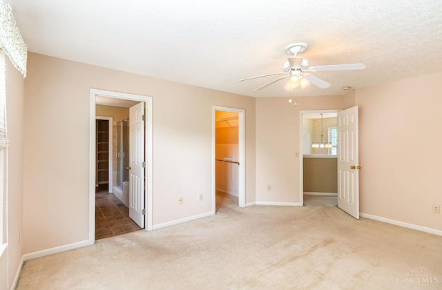 7693 Misty Springs Ct, Deerfield Twp, OH 45040 - unfurnished bedroom featuring a spacious closet, carpet floors, a closet, a ceiling fan, and connected bathroom