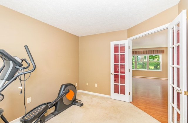 7693 Misty Springs Ct, Deerfield Twp, OH 45040 - workout room featuring french doors, a textured ceiling, and wood finished floors