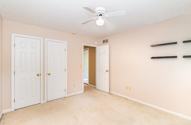 7693 Misty Springs Ct, Deerfield Twp, OH 45040 - unfurnished bedroom featuring light colored carpet, multiple closets, and a ceiling fan