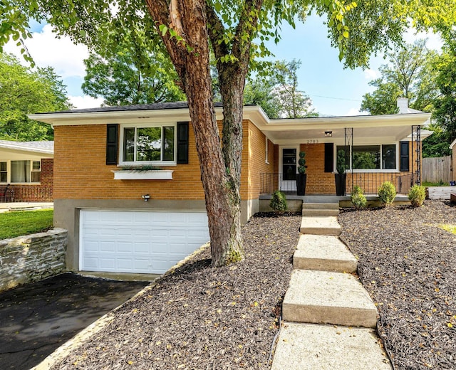 2783 Losantiridge Ave, Columbia Twp, OH 45213 - view of front of house featuring an attached garage, driveway, brick siding, and a porch