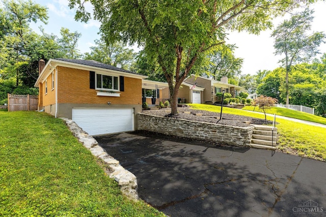 2783 Losantiridge Ave, Columbia Twp, OH 45213 - view of front of home with driveway, a garage, a chimney, and brick siding