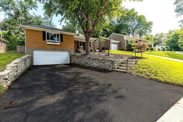 2783 Losantiridge Ave, Columbia Twp, OH 45213 - view of front facade with a garage, driveway, brick siding, and a front yard