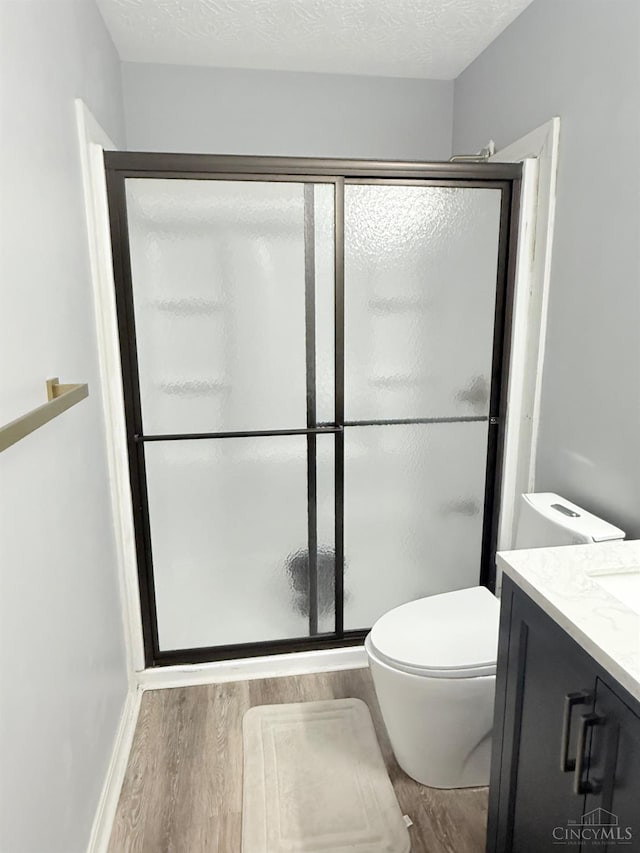 7912 Jessies Way Unit 304, Fairfield Twp, OH 45011 - bathroom with wood finished floors, vanity, and a stall shower