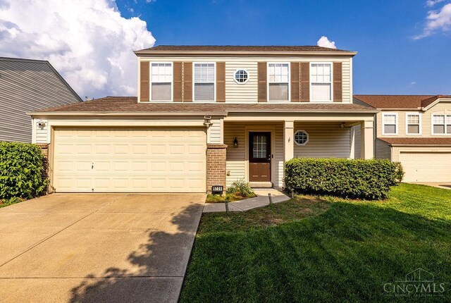 6706 Bedington Ln, Morrow, OH 45152 - view of front facade with concrete driveway, a front lawn, a garage, and brick siding