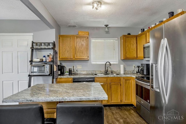 6706 Bedington Ln, Morrow, OH 45152 - kitchen with appliances with stainless steel finishes, a textured ceiling, dark wood-style flooring, light stone countertops, and open shelves