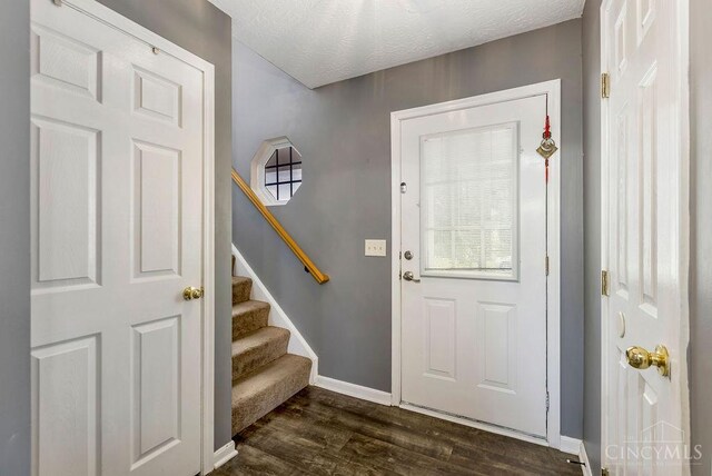 6706 Bedington Ln, Morrow, OH 45152 - foyer with stairs, dark wood finished floors, and a textured ceiling