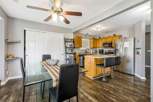 6706 Bedington Ln, Morrow, OH 45152 - dining area featuring ceiling fan and dark wood-style flooring