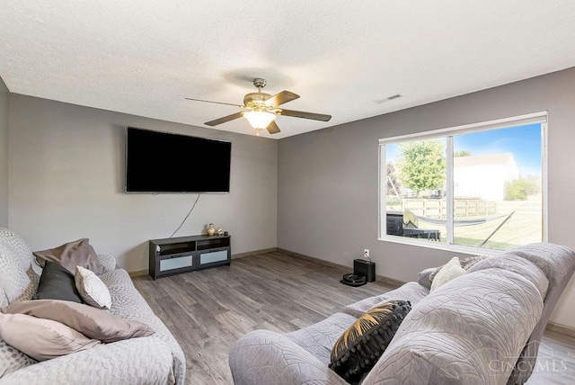 6706 Bedington Ln, Morrow, OH 45152 - living area featuring a ceiling fan, light wood-style floors, and a textured ceiling