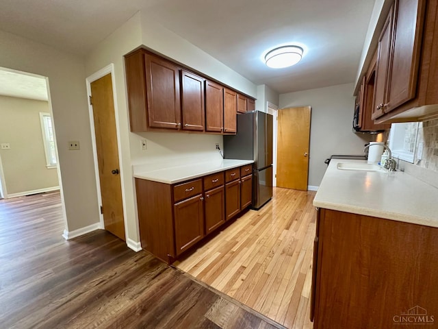 1285 Oakmont Dr, Hamilton, OH 45013 - kitchen featuring freestanding refrigerator, light wood-style floors, and light countertops