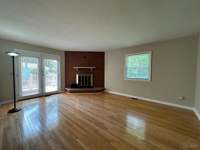 1285 Oakmont Dr, Hamilton, OH 45013 - unfurnished living room with hardwood / wood-style floors, french doors, and a fireplace