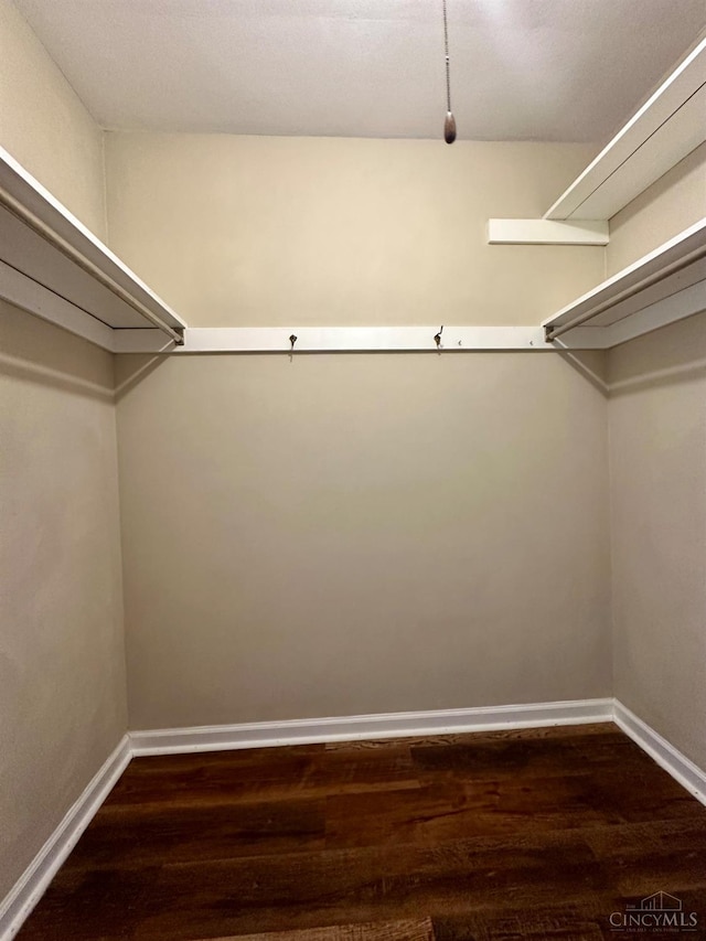 1285 Oakmont Dr, Hamilton, OH 45013 - walk in closet with dark wood-style flooring