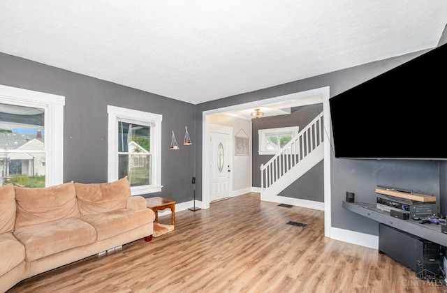 609 Coralie Ave, Hamilton, OH 45013 - living area featuring light wood-style floors, healthy amount of natural light, and stairs
