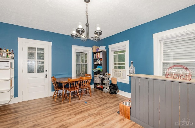 609 Coralie Ave, Hamilton, OH 45013 - dining room with a chandelier, wood finished floors, a textured ceiling, and cooling unit