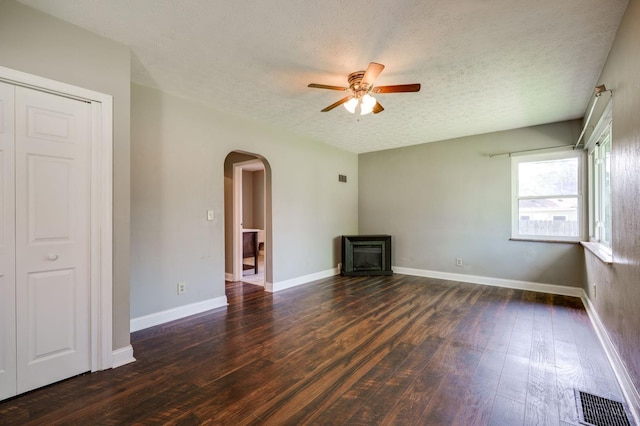 732 Central Ave, Carlisle, OH 45005 - unfurnished living room featuring arched walkways, a textured ceiling, ceiling fan, and dark wood-type flooring