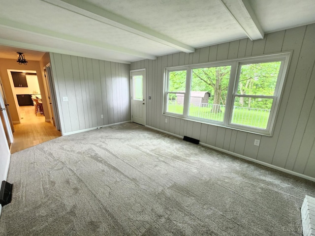 2191 Flomar Ct, Green Twp, OH 45233 - unfurnished room with carpet, beam ceiling, wood walls, and a chandelier