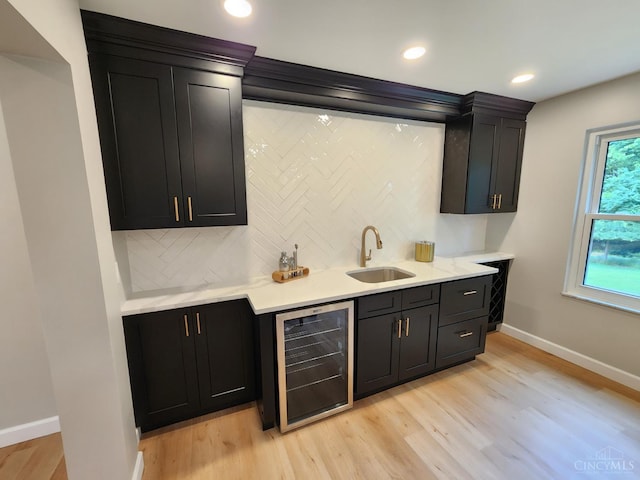 2191 Flomar Ct, Green Twp, OH 45233 - indoor wet bar with beverage cooler, backsplash, light wood finished floors, and recessed lighting