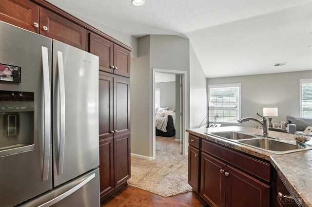 7981 Oakbridge Way, Green Twp, OH 45248 - kitchen with stainless steel fridge, dark wood-style flooring, lofted ceiling, and open floor plan