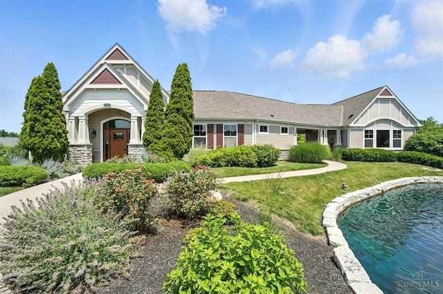 7981 Oakbridge Way, Green Twp, OH 45248 - craftsman inspired home with stone siding, a front yard, and board and batten siding