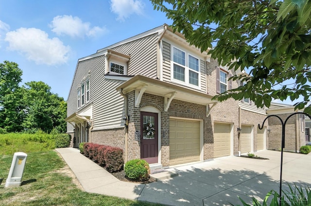 7981 Oakbridge Way, Green Twp, OH 45248 - view of front of house featuring a garage, concrete driveway, and brick siding