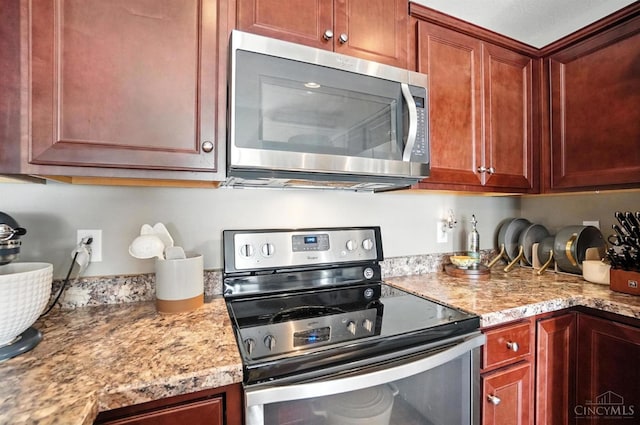 7981 Oakbridge Way, Green Twp, OH 45248 - kitchen with stainless steel appliances and light stone countertops