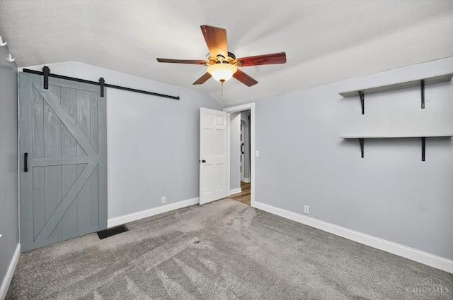 4644 Alpine Ave, Blue Ash, OH 45242 - unfurnished bedroom with vaulted ceiling, carpet flooring, a barn door, and a ceiling fan