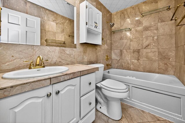 4644 Alpine Ave, Blue Ash, OH 45242 - full bathroom with vanity, bathing tub / shower combination, tasteful backsplash, and tile walls