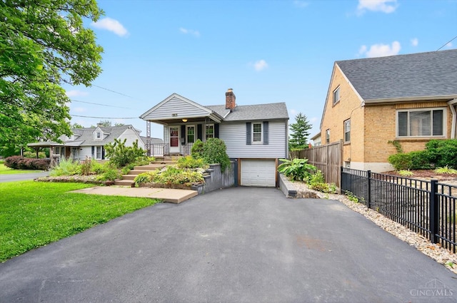 4644 Alpine Ave, Blue Ash, OH 45242 - view of front of property with a chimney, driveway, an attached garage, brick siding, and roof with shingles