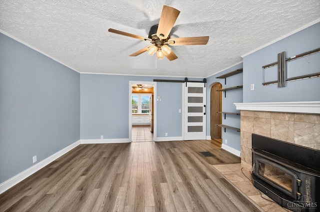 4644 Alpine Ave, Blue Ash, OH 45242 - unfurnished living room featuring wood finished floors, a textured ceiling, a wood stove, crown molding, and a ceiling fan