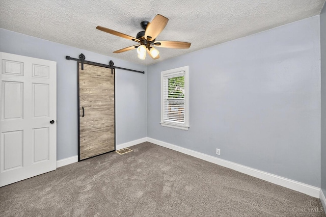 4644 Alpine Ave, Blue Ash, OH 45242 - unfurnished bedroom featuring a barn door, carpet flooring, a textured ceiling, and ceiling fan
