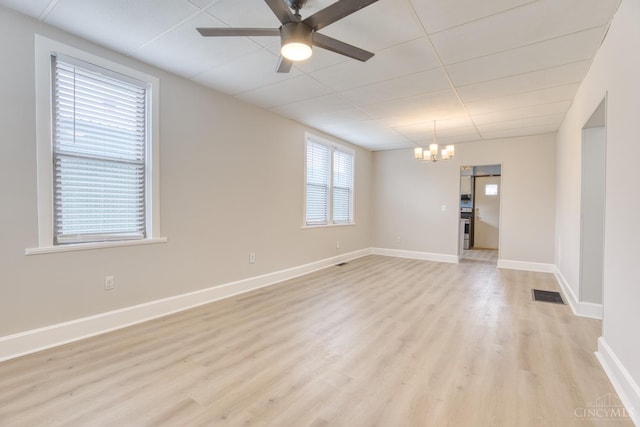 2315 Elbe Ave, Hamilton, OH 45015 - unfurnished room featuring a ceiling fan, light wood finished floors, and a chandelier